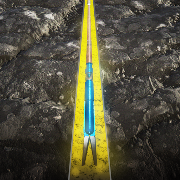 A farming tool with a blue handle and forked end is shown lying in a yellow-lined furrow on a soil field.