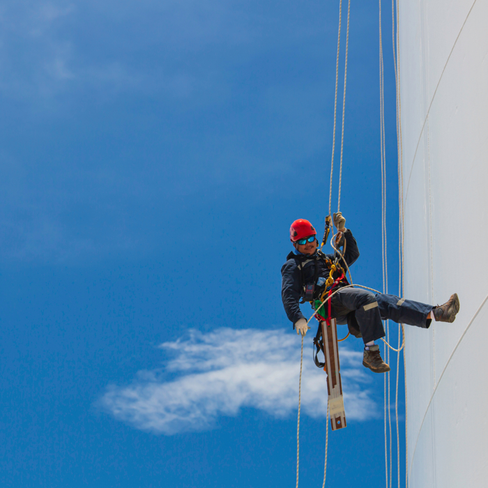 man doing rope access work on a wind turbine